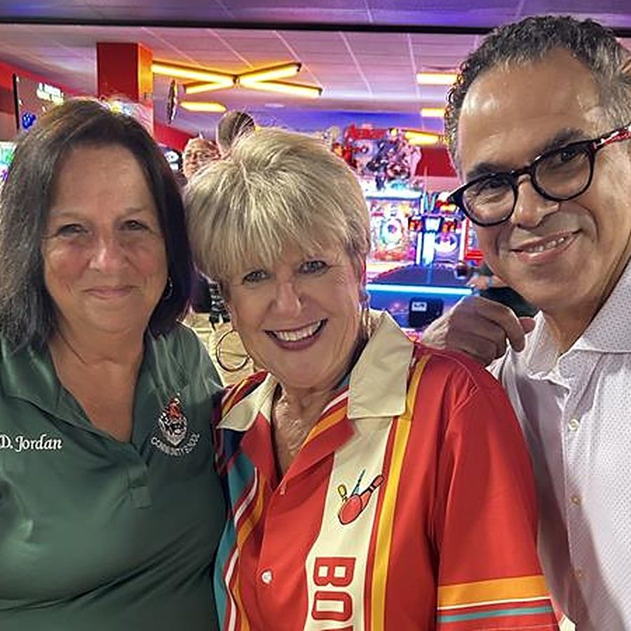 Sponsors engaging at a bowling mixer with board members